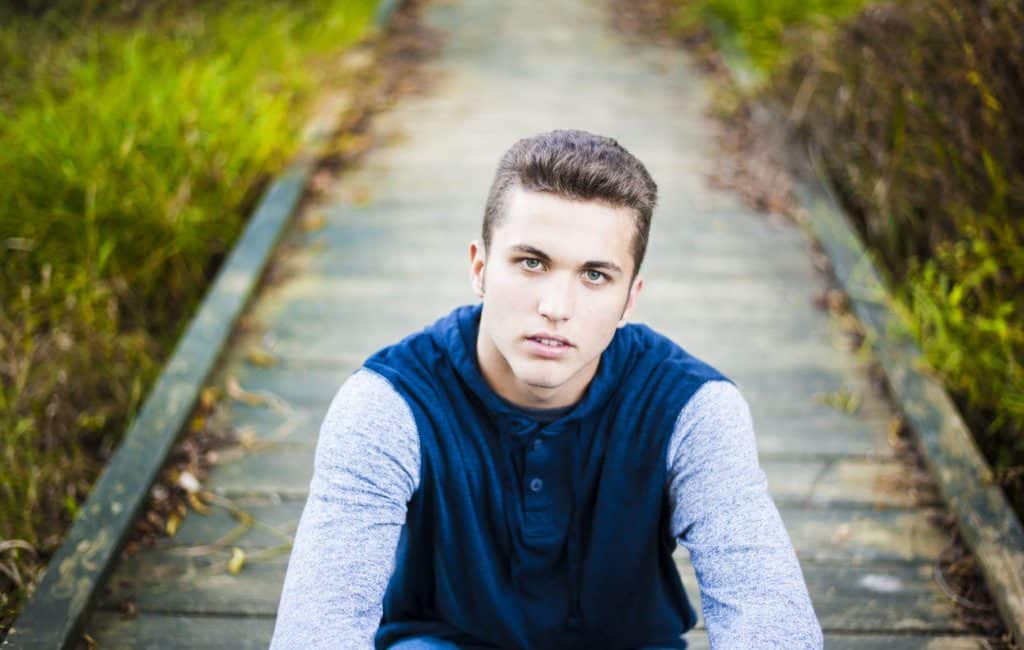 Handsome young male model posing outdoors in blue shirt and sunglasses  Stock Photo by ©matusciac 21438099