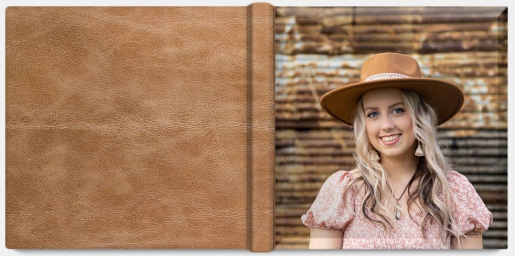 A distressed brown leather photo album with a crystal cover featuring one image.