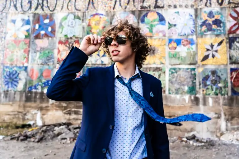 Senior picture of a cool looking kid wearing sunglasses and a suit with his tie flying in the wind by Tonya Bolton photography.