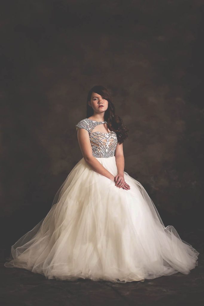 Classis beauty portrait of a young girl in a white beaded gown.