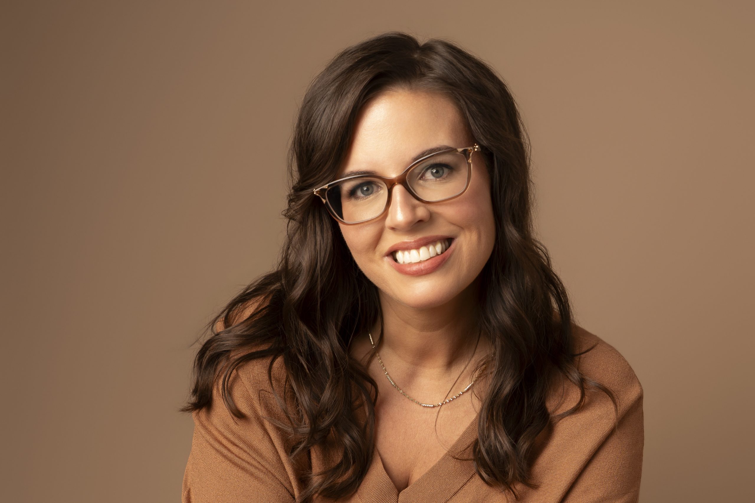business portrait of a woman on a neutral background in a photography studio