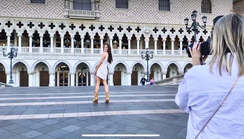A girl getting her portrait made in front of the Venetian Hotel in Las Vegas by Tonya Bolton Photography who is known quite well for her lavish senior photo shoots.