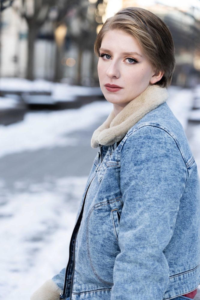High school senior standing for a photography session in cincinnati during winter at Piatt Park